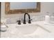 Modern bathroom vanity featuring marble countertop and black faucet at 2313 N 66Th St, Scottsdale, AZ 85257