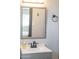 Bright bathroom with a gray framed mirror and a matte black faucet, offering a minimalist design at 2313 N 66Th St, Scottsdale, AZ 85257