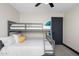 Shared bedroom with bunkbeds, a ceiling fan, neutral walls, and a stylish dark door at 2313 N 66Th St, Scottsdale, AZ 85257