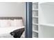 Partially-viewed bedroom with a white shelf, adding a neat storage for linens and bedroom supplies at 2313 N 66Th St, Scottsdale, AZ 85257