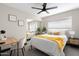 Cozy bedroom with mirrored closet doors, a ceiling fan, and a bright window view at 2313 N 66Th St, Scottsdale, AZ 85257