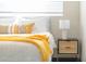 Bright bedroom with neutral bedding and a wooden nightstand with a lamp, perfect for relaxation at 2313 N 66Th St, Scottsdale, AZ 85257