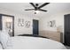 Bedroom with modern ceiling fan, dresser, art and an ensuite bathroom at 2313 N 66Th St, Scottsdale, AZ 85257