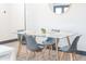 Stylish dining room features a modern glass-top table and gray chairs at 2313 N 66Th St, Scottsdale, AZ 85257