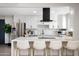 Bright, renovated kitchen featuring stainless steel appliances, white cabinetry, and a breakfast bar at 2313 N 66Th St, Scottsdale, AZ 85257