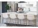 Modern kitchen featuring a large island with white countertops and stylish bar stools, creating a gathering space at 2313 N 66Th St, Scottsdale, AZ 85257