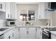 Charming kitchen with white cabinets, stainless appliances, and eye-catching backsplash at 2313 N 66Th St, Scottsdale, AZ 85257