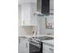 Close-up on the stainless steel stove with a white countertop, white cabinets, and unique hexagon backsplash at 2313 N 66Th St, Scottsdale, AZ 85257