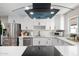 Bright kitchen featuring stainless steel appliances, white cabinets, and a modern range hood at 2313 N 66Th St, Scottsdale, AZ 85257