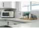 Bright kitchen boasts modern appliances, white cabinets, and stylish countertops at 2313 N 66Th St, Scottsdale, AZ 85257