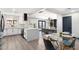 Open-concept kitchen and dining area with an island bar, modern finishes, and a view into the living room at 2313 N 66Th St, Scottsdale, AZ 85257
