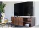 Modern living room with a sleek TV console and decorative items, providing storage and style at 2313 N 66Th St, Scottsdale, AZ 85257