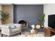 Cozy living room showcasing a brick fireplace, comfortable seating, and elegant decor at 2313 N 66Th St, Scottsdale, AZ 85257