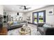 Beautifully staged living room open to the kitchen, featuring a plush sofa and access to the backyard at 2313 N 66Th St, Scottsdale, AZ 85257