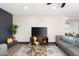 Comfortable living room featuring a TV, decorative fireplace, modern furniture, and stylish decor at 2313 N 66Th St, Scottsdale, AZ 85257