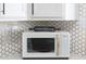 Modern kitchen features a microwave with decorative rolling pin at 2313 N 66Th St, Scottsdale, AZ 85257