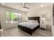 Comfortable bedroom featuring a large window with views and a modern ceiling fan at 27418 W Mohawk Ln, Buckeye, AZ 85396