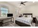 Cozy bedroom featuring neutral tones, a work space, and plush bedding at 27418 W Mohawk Ln, Buckeye, AZ 85396