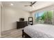Serene bedroom with a large window, dresser, and a walk-in closet at 27418 W Mohawk Ln, Buckeye, AZ 85396