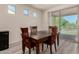 Cozy dining area with a sliding glass door leading to an outdoor space and lots of natural light at 27418 W Mohawk Ln, Buckeye, AZ 85396