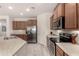 Functional kitchen with stainless steel appliances, sleek countertops, and plentiful cabinetry at 27418 W Mohawk Ln, Buckeye, AZ 85396