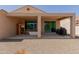 Covered patio with sauna, soaking tub, grill and low-maintenance gravel landscaping at 27418 W Mohawk Ln, Buckeye, AZ 85396