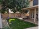 Backyard featuring a covered patio, lush greenery, and mature trees at 2955 E Hermosa Vista Dr, Mesa, AZ 85213