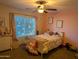 Pink bedroom with a white bed, lots of stuffed animals, and a window view at 2955 E Hermosa Vista Dr, Mesa, AZ 85213