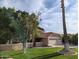 Charming home featuring a spacious garage, green lawn, mature trees, and a red tile roof at 2955 E Hermosa Vista Dr, Mesa, AZ 85213