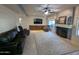 Comfortable living room featuring a fireplace, ceiling fan, and large area rug at 2955 E Hermosa Vista Dr, Mesa, AZ 85213
