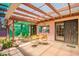 Back patio featuring a dining set, exterior lights, and a pink exterior at 3247 E Sheridan St, Phoenix, AZ 85008