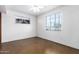 Simple bedroom with two windows letting in natural light and bare floors at 3247 E Sheridan St, Phoenix, AZ 85008