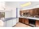 Bright eat-in kitchen featuring classic wood cabinetry, a breakfast bar, and plenty of counter space at 3247 E Sheridan St, Phoenix, AZ 85008