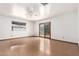 Living area with hardwood floors, ceiling fan, and sliding door that leads to the backyard at 3247 E Sheridan St, Phoenix, AZ 85008