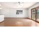 Living area with hardwood floors, ceiling fan, and sliding door that leads to the backyard at 3247 E Sheridan St, Phoenix, AZ 85008