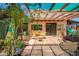 Inviting patio area with overhead coverings, a dining set, and lush plants creating a delightful outdoor space at 3247 E Sheridan St, Phoenix, AZ 85008