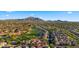 Aerial view of a community showcasing mountain views, golf course, and neighborhood layout at 3277 E Meadowview Dr, Gilbert, AZ 85298
