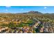 Charming home with a two-car garage, lush desert landscaping, and serene mountain views in golf course community at 3277 E Meadowview Dr, Gilbert, AZ 85298