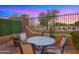 Cozy patio with dining set, with views of golf course and pink and blue sky at 3277 E Meadowview Dr, Gilbert, AZ 85298