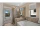 Tiled bathroom featuring walk-in shower, soaking tub, and light from the window at 3277 E Meadowview Dr, Gilbert, AZ 85298
