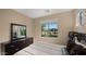 Cozy bedroom with large window and a dark wood dresser topped with a mirror at 3277 E Meadowview Dr, Gilbert, AZ 85298