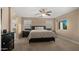 A bright bedroom with a ceiling fan, large bed and side tables at 3277 E Meadowview Dr, Gilbert, AZ 85298