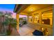 Back of house with covered patio, outdoor dining set, grill and lush vegetation at 3277 E Meadowview Dr, Gilbert, AZ 85298