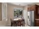 Eat in kitchen area features a table and chairs next to a window and stainless refrigerator at 3277 E Meadowview Dr, Gilbert, AZ 85298