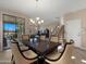 Formal dining room with neutral tones, stylish chandelier, and sliding glass doors to the outdoor patio at 3277 E Meadowview Dr, Gilbert, AZ 85298