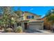 Charming two-story home with a well-manicured lawn and a beautiful tree in the front yard under a clear blue sky at 3277 E Meadowview Dr, Gilbert, AZ 85298