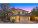 Charming two-story home with beautiful light at dusk and manicured lawn at 3277 E Meadowview Dr, Gilbert, AZ 85298