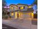 Charming two-story home featuring a spacious driveway, well-lit exterior, and manicured landscaping at 3277 E Meadowview Dr, Gilbert, AZ 85298