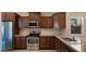 Kitchen with stainless steel appliances, granite countertops, tile backsplash and brown cabinetry at 3277 E Meadowview Dr, Gilbert, AZ 85298