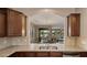 Kitchen view showcasing granite countertops and a pass-through to the dining and living areas at 3277 E Meadowview Dr, Gilbert, AZ 85298